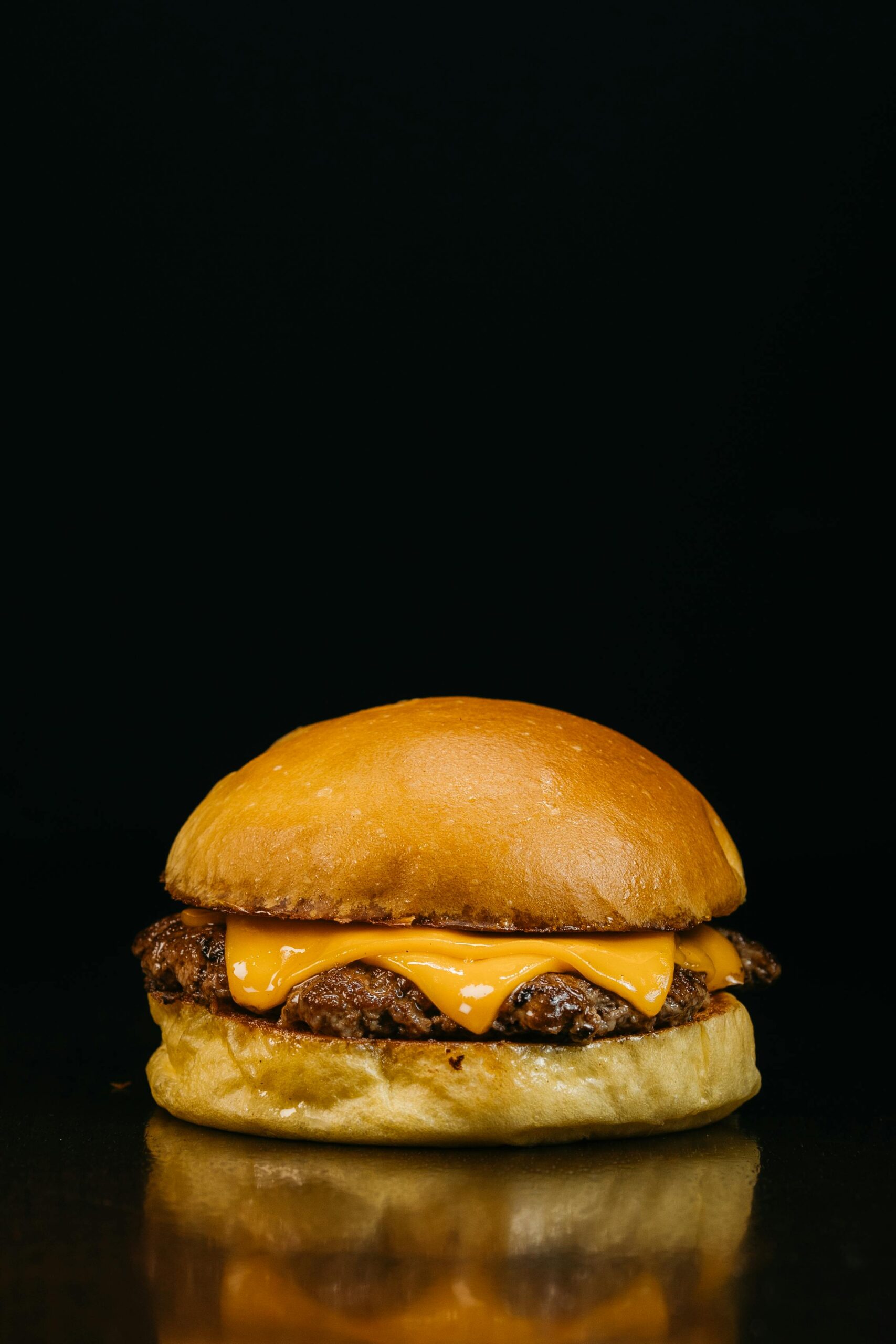 Close-up shot of a delicious cheeseburger with juicy beef and melted cheese.